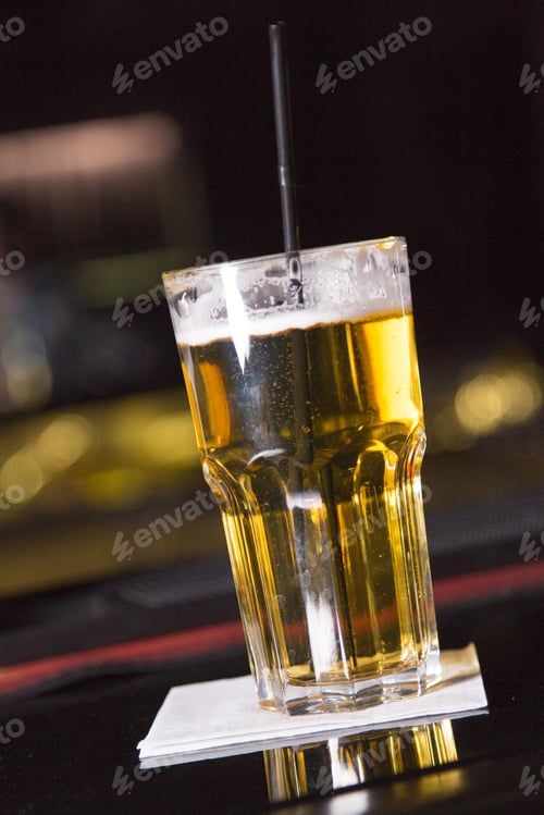 Preview: An Alcoholic Yellow Cocktail Is In Beautiful Glass, On The Bar