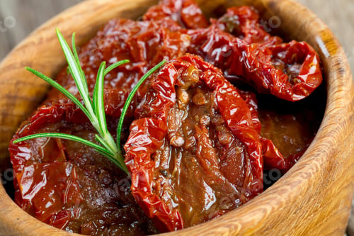 Preview: Sun Dried Tomatoes With Olive Oil On Wooden Surface