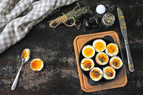 Preview: Soft-Boiled Eggs In A Skillet. Spices And Thyme. Stylish Breakfast On A Dark Surface.