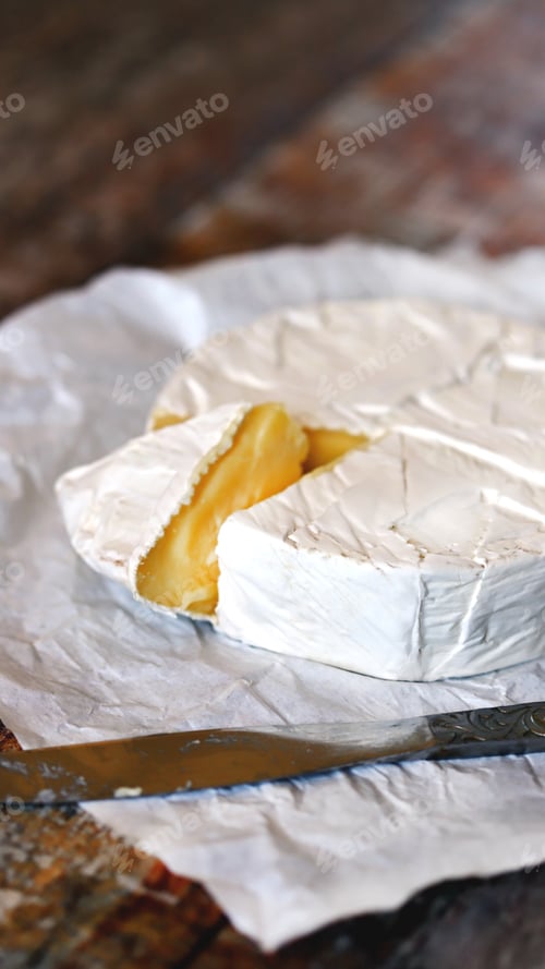 Preview: Selective Focus. Camembert Cheese In White Paper. Fresh Camembert Cheese.