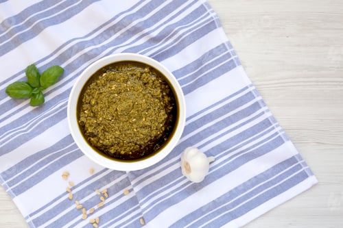 Preview: Homemade Basil Pesto With Parmesan And Pine Nuts On A White Wooden Background, Overhead View. Flat
