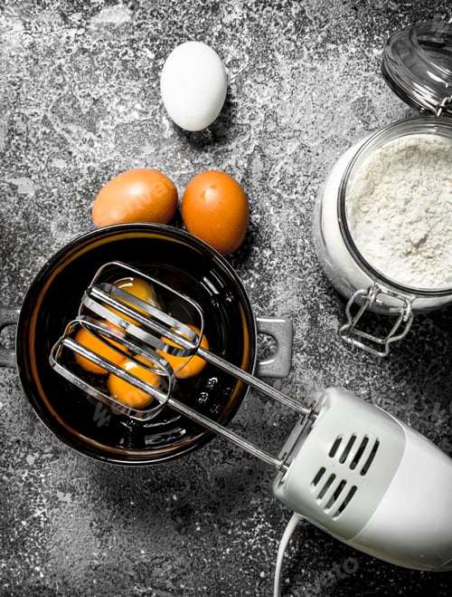 Preview: Baking Background. Blend Eggs With A Mixer To Make A Dough. On A Rustic Background.