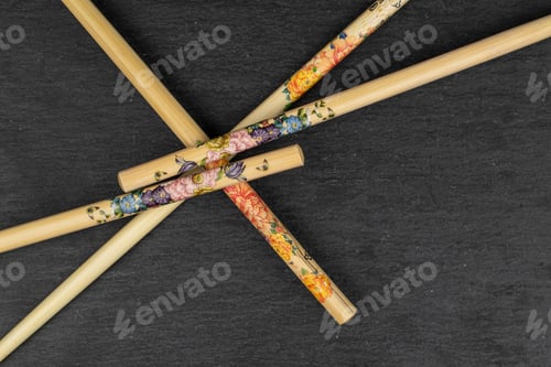 Preview: Group Of Four Whole Asian Brown Chopsticks Flatlay On Grey Stone