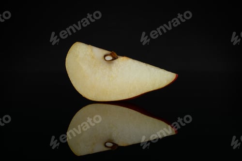 Preview: One Slice Of Fresh Dark Red Pear Anjou Isolated On Black Glass