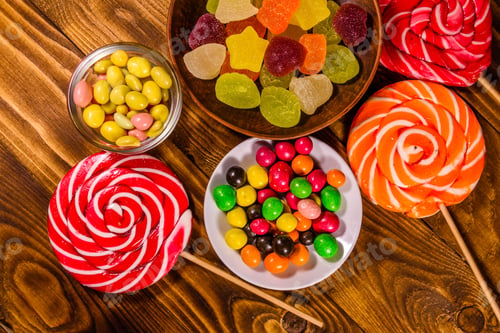 Preview: Different Sweet Candies On Rustic Wooden Table. Top View