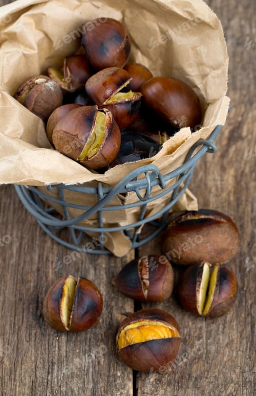 Preview: Roasted Chestnuts On Wooden Surface