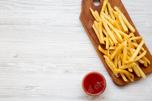 Preview: French Fries On Wooden Board And Ketchup Over White Wooden Background, Top View. From Above, Flat