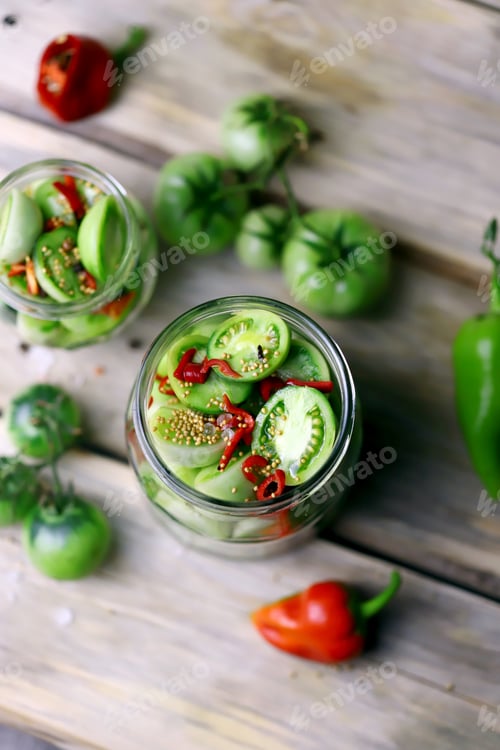 Preview: Green Tomatoes In Jars On A Wooden Surface. Fermentation Of Green Tomatoes. Country Style
