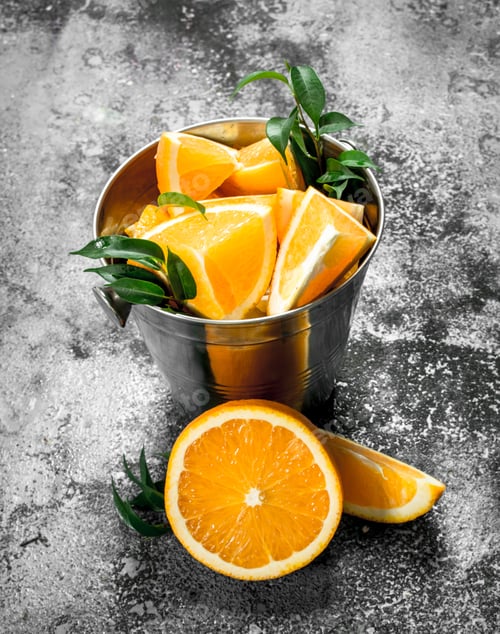 Preview: Fresh Slices Of Oranges In Steel Bucket. On A Rustic Background.