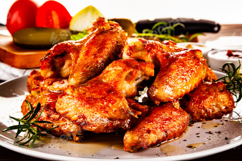 Preview: Barbecued Chicken Wings With French Fries And Vegetable Salad On Timber