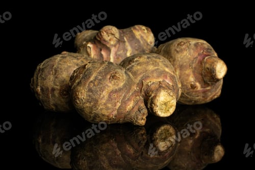 Preview: Group Of Five Whole Fresh Brown Jerusalem Artichoke Isolated On Black Glass