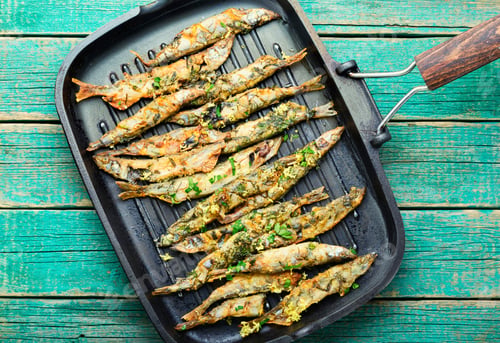 Preview: Fried Capelin Garnished With Parsley And Lemon Zest In A Pan