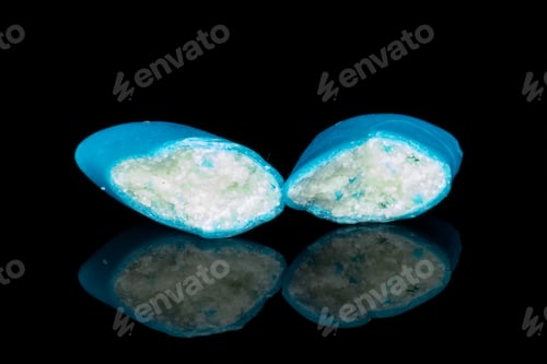 Preview: Group Of Two Halves Of Blue Chewing Gum Isolated On Black Glass