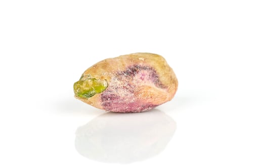 Preview: One Whole Ripe Green Pistachio Without Shell In Closeup Isolated On White Background