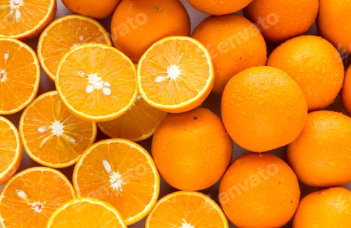 Preview: A Closeup Of A Pile Of Oranges Sliced And Whole