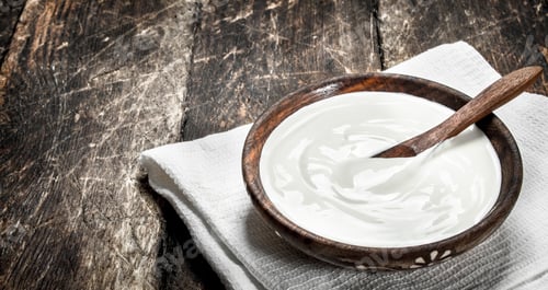 Preview: Natural Yogurt In A Bowl. On A Wooden Background.