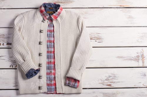 Preview: White Knit Cardigan and Plaid Shirt on Wood
