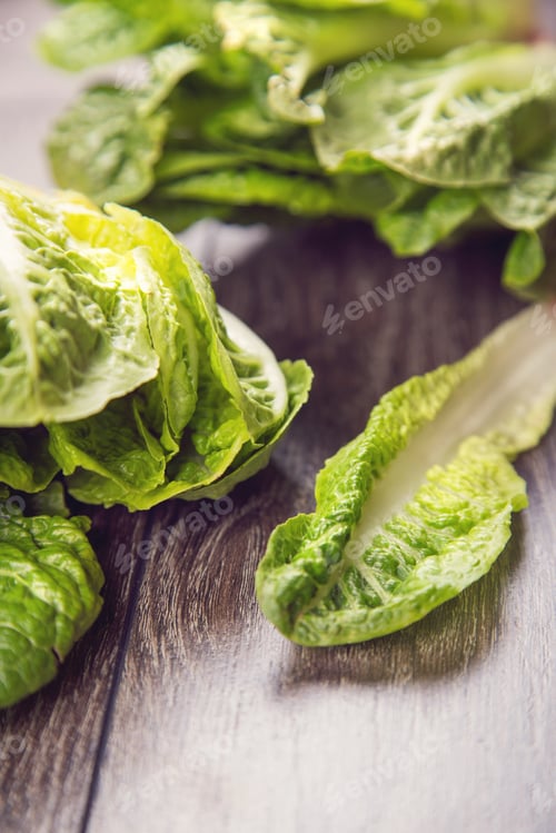 Preview: Few Fresh Leaf Of Raw Ripe Salad Romen On Wooden Background