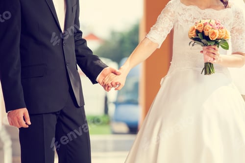 Preview: Wedding Couple Holding Hands With Flower Holding