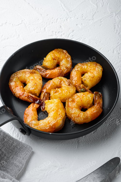 Preview: Delicious Sauteed Shrimp With Cajun Seasoning, Curry And Lime Set, On Frying Iron Pan, On White