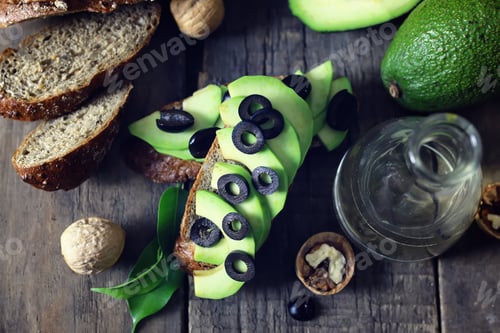 Preview: Avocado Bread Olives On A Wooden Background