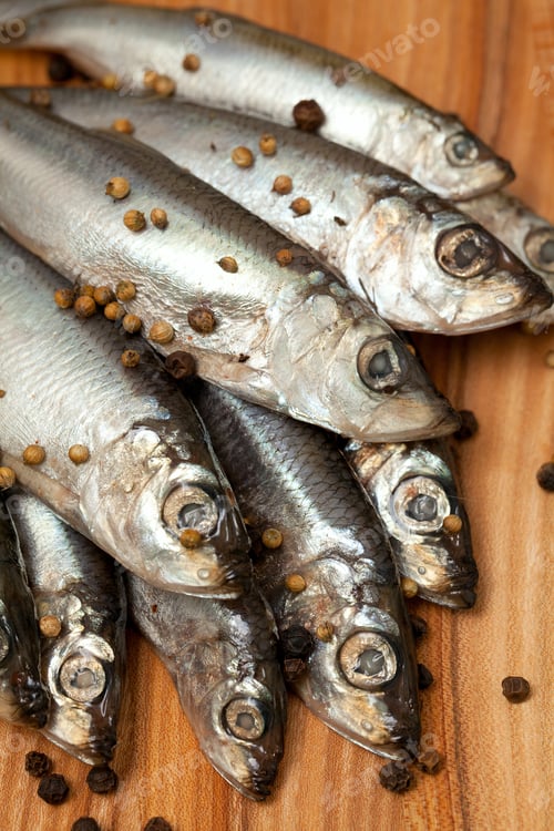 Preview: Sprat Fish With Peppercorns On Wooden Board