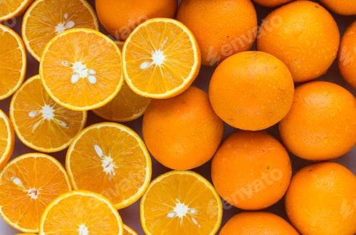 Preview: A Closeup Of A Pile Of Oranges Sliced And Whole