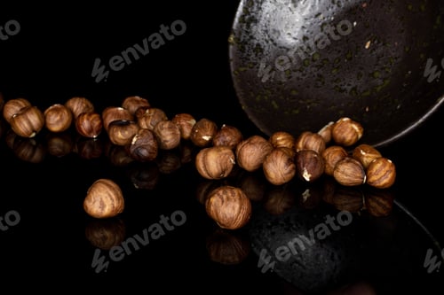 Preview: Lot Of Whole Peeled Tasty Brown Hazelnut In Glazed Bowl Isolated On Black Glass