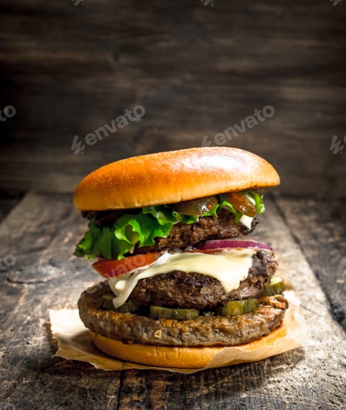 Preview: Big Burger With Beef, Tomatoes And Greens. On A Wooden Background.