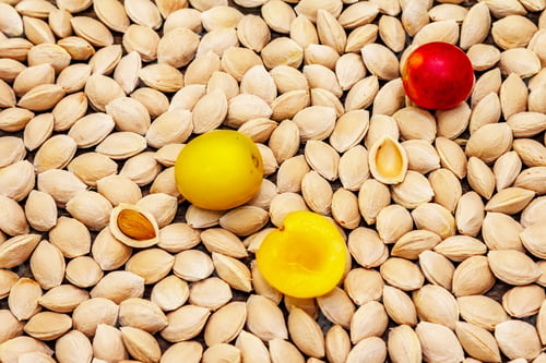Preview: Cherry Plum Seeds, Whole And Half Fruits. Wooden Background, Close Up