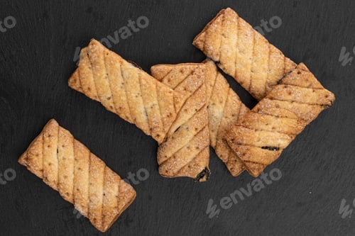 Preview: Lot Of Whole Square Puff Cookie With Raisins On Grey Stone