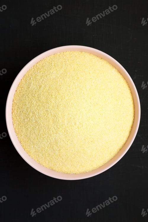 Preview: Dry Semolina Durum Flour In A Pink Bowl Over Black Surface, Top View. From Above, Overhead, Flat