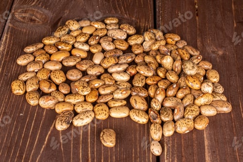 Preview: Lot Of Whole Mottled Brown Bean Pinto On Brown Wood