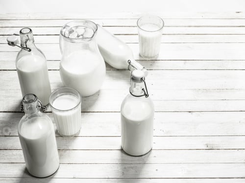 Preview: Fresh Milk In Bottles . On A White Wooden Table.