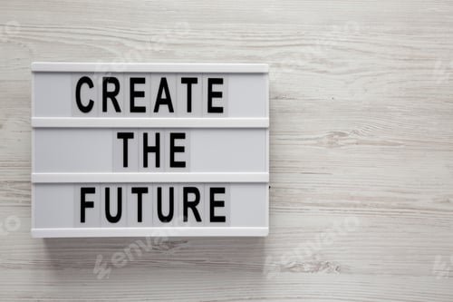 Preview: Modern Board With Text 'Create The Future' On A White Wooden Table, Top View. From Above, Flat Lay