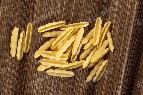 Preview: Lot Of Whole Uncooked Pasta Cavatelli Flatlay On Brown Textured Cloth
