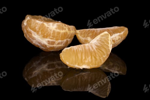 Preview: Group Of One Half Two Pieces Of Fresh Orange Mandarin Isolated On Black Glass