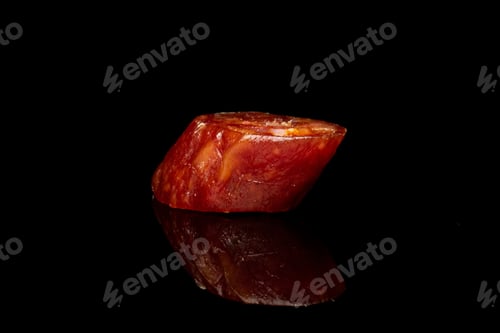 Preview: One Slice Of Piquant Smoked Sausage Isolated On Black Glass