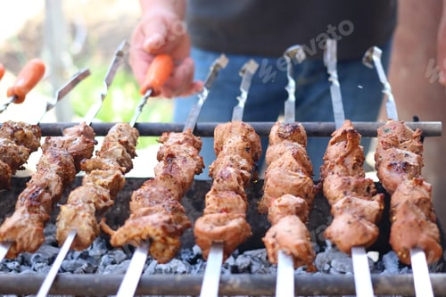Preview: On The Barbecue, A Lot Of Meat Is Roasted On Skewers, The Chef Turns Over His Shish Kebabs. A Man'S