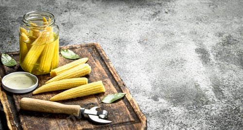 Preview: Pickled Corn In A Jar On A Cutting Board. On A Rustic Background.