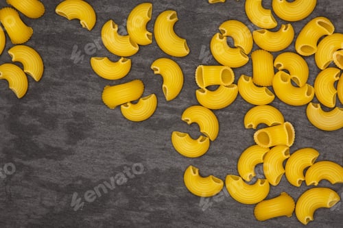 Preview: Lot Of Whole Raw Pasta Pipe Rigate Variety With Copyspace Flatlay On Grey Stone
