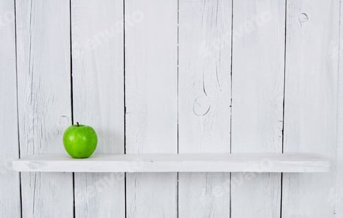 Preview: One Green Apple On A Shelf. A Wooden, White Background.