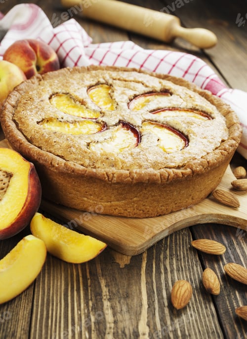 Preview: Peach Pie With Almonds In The Ceramic Pot On The Wooden Table