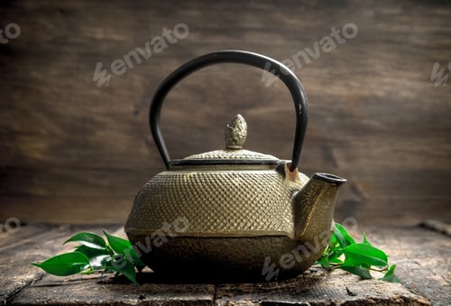 Preview: Teapot With Fragrant Indian Tea. On A Wooden Background.