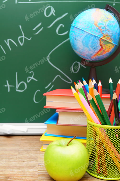 Preview: Apples And School Accessories Against A School Board.