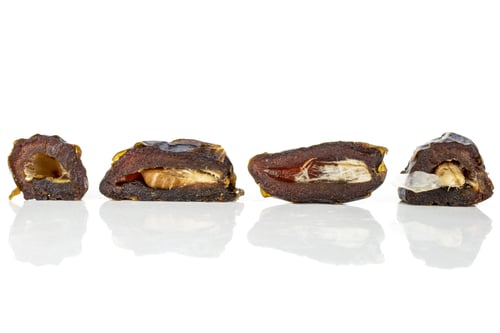 Preview: Group Of Four Halves Of Dried Brown Date Medjool Isolated On White Background