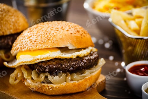 Preview: Tasty Burgers With French Fries And Vegetables On Cutting Board