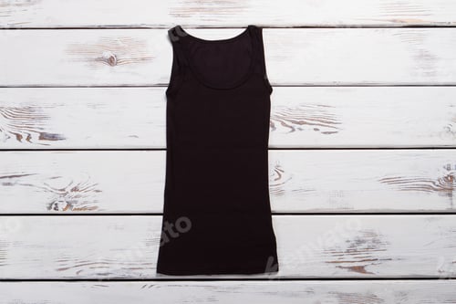 Preview: Black Classic T-Shirt For Every Day. Women Knitted T-Shirt On A Wooden Background.