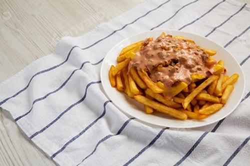 Preview: Homemade Animal Style French Fries On A White Plate, Side View. Copy Space.