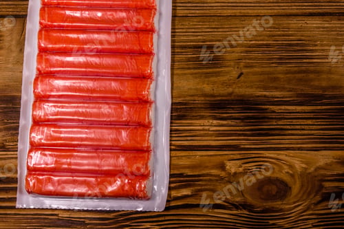 Preview: Vacuum Pack Of Crab Sticks On Wooden Table. Top View